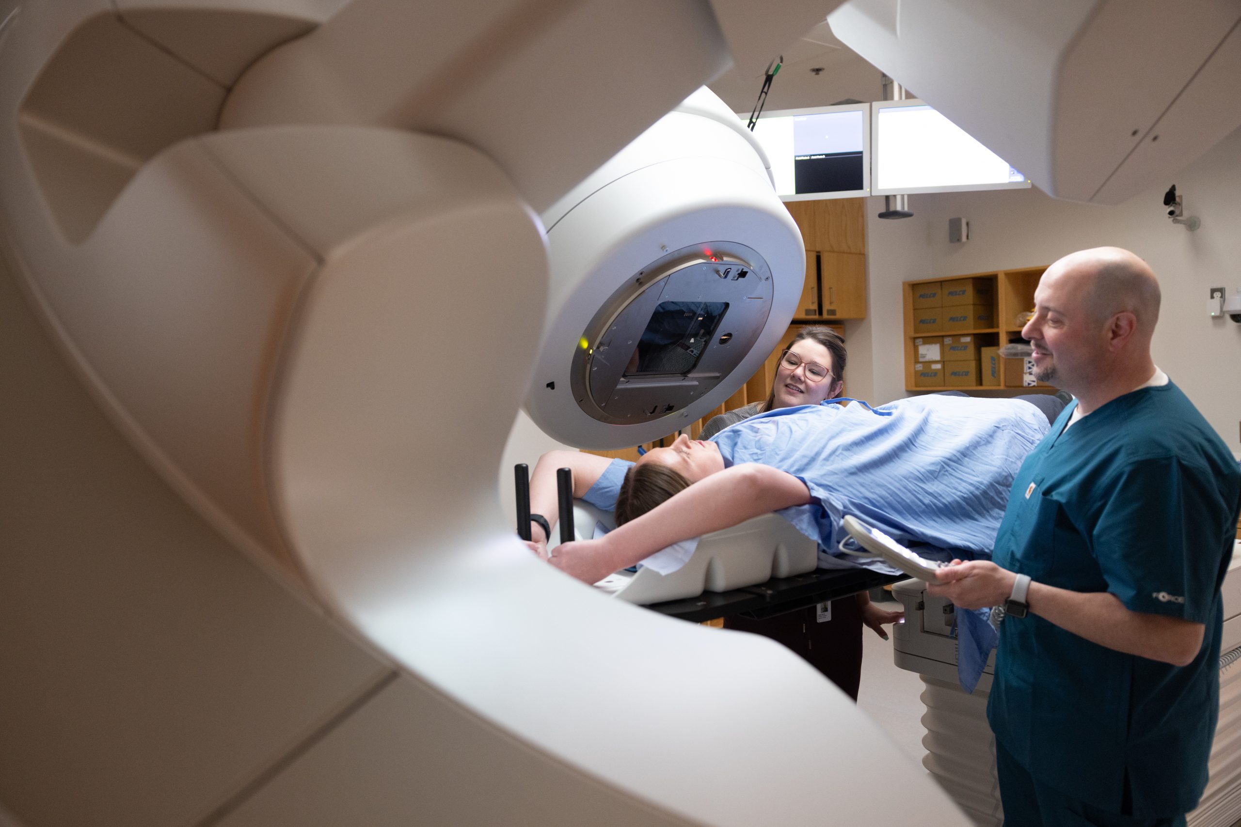 A woman lying on a machine.